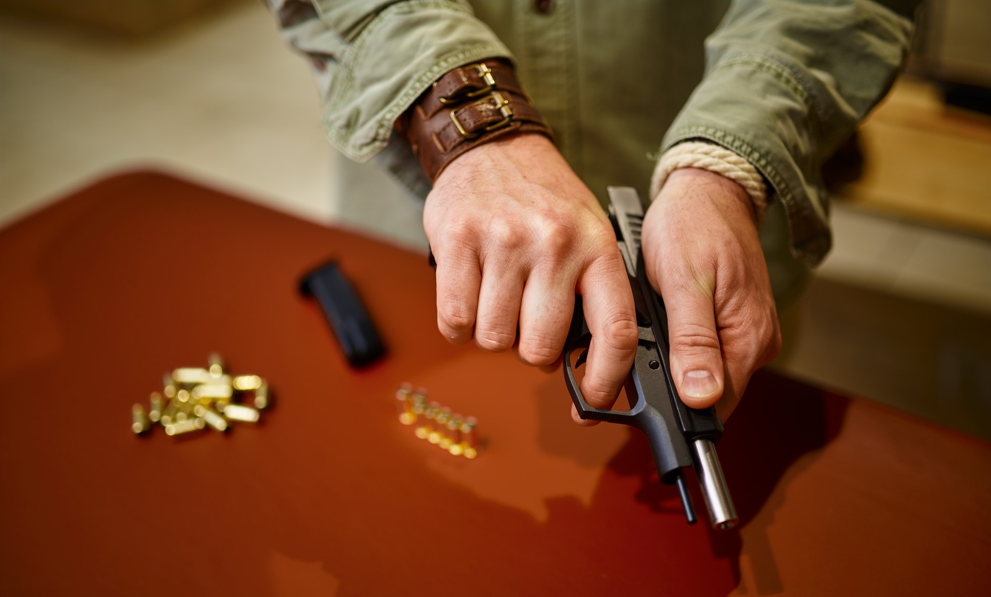 Man loads the gun with bullets in gun store